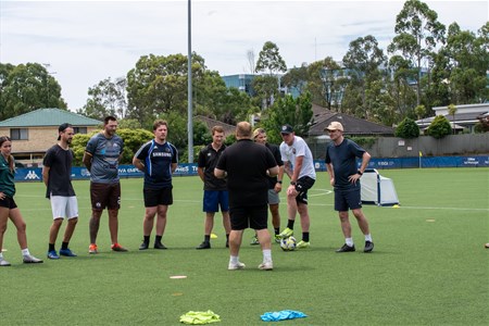 a group of people playing football on a field