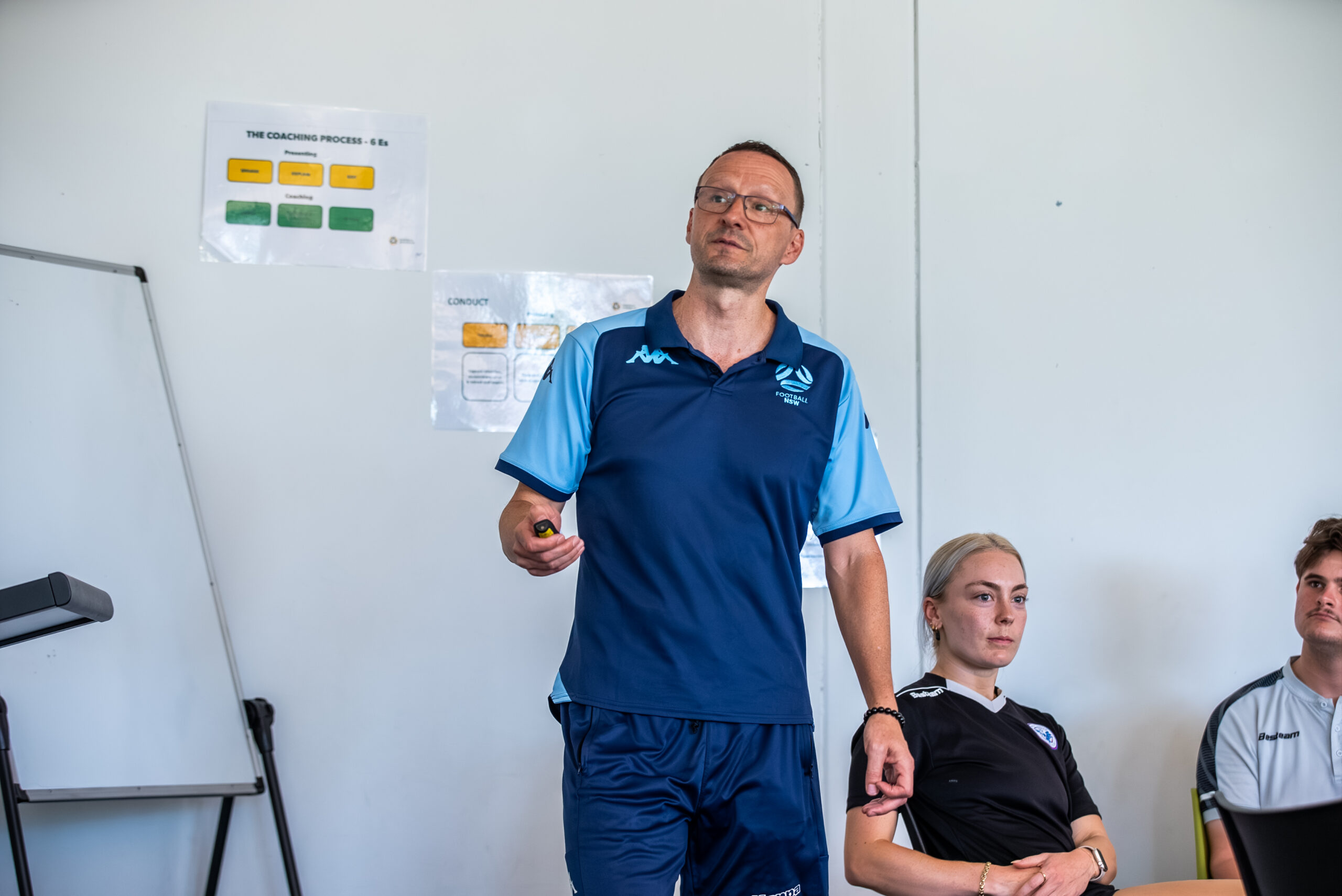 a man standing in front of a group of people posing for the camera