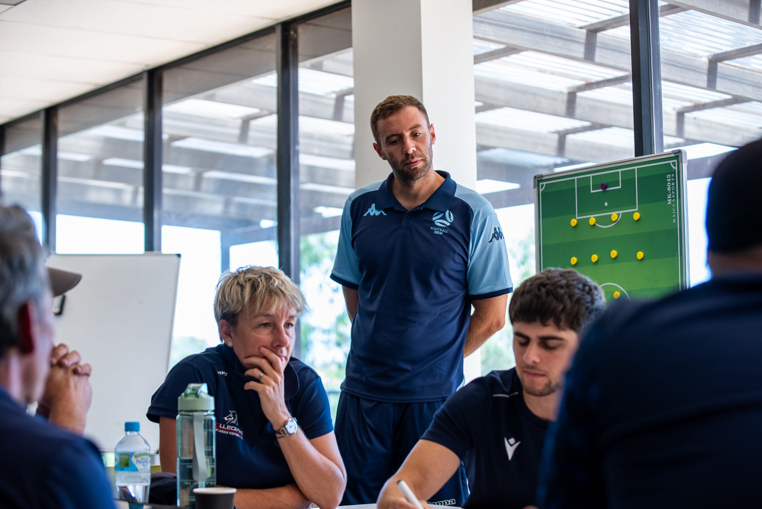 a group of people standing in front of a window