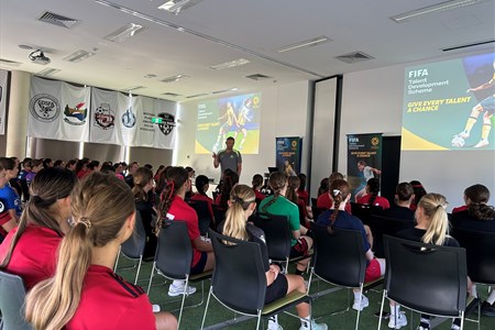 a group of people standing in front of a crowd posing for the camera