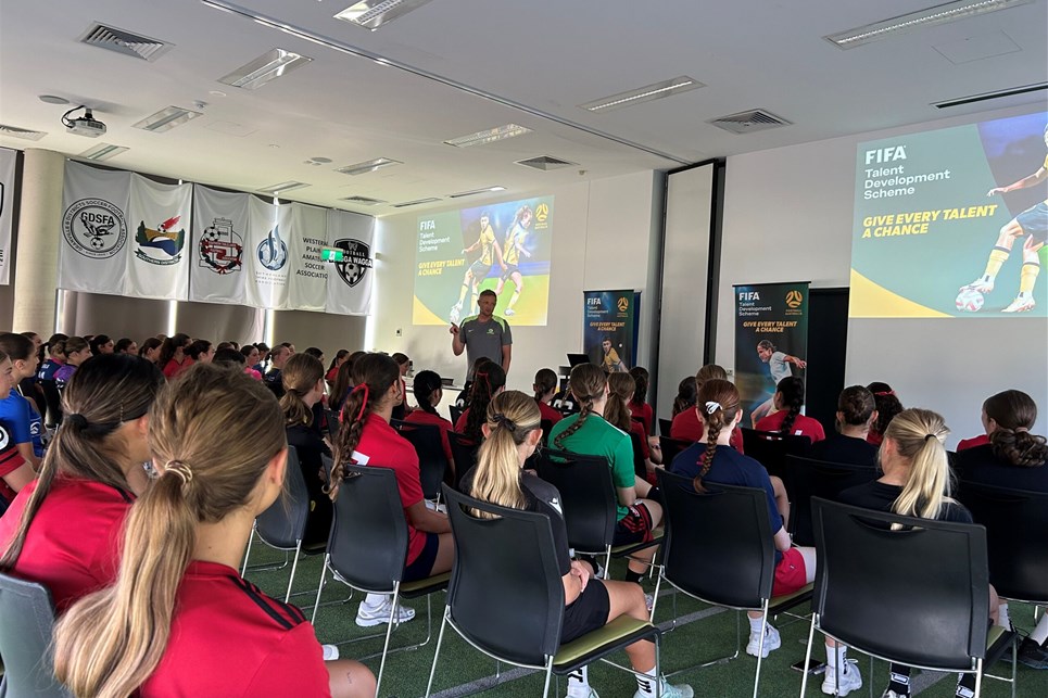 a group of people standing in front of a crowd posing for the camera