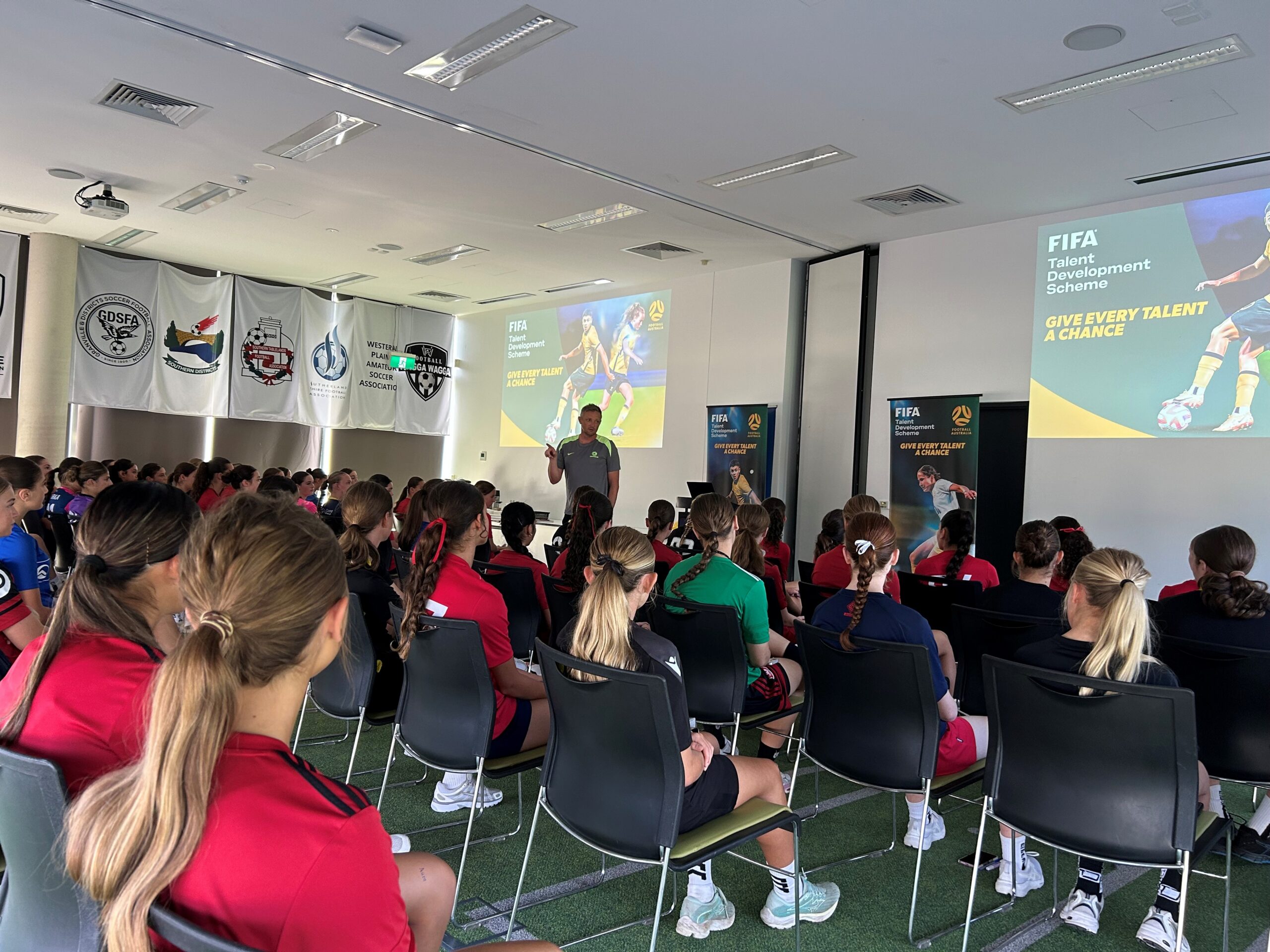 a group of people standing in front of a crowd posing for the camera
