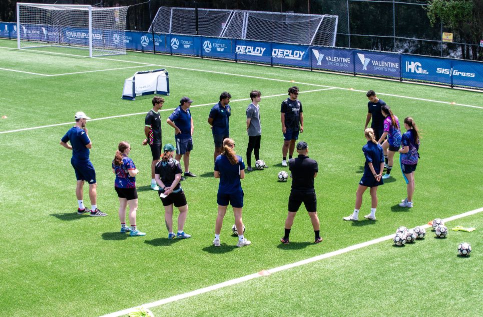 a group of people playing football on a field