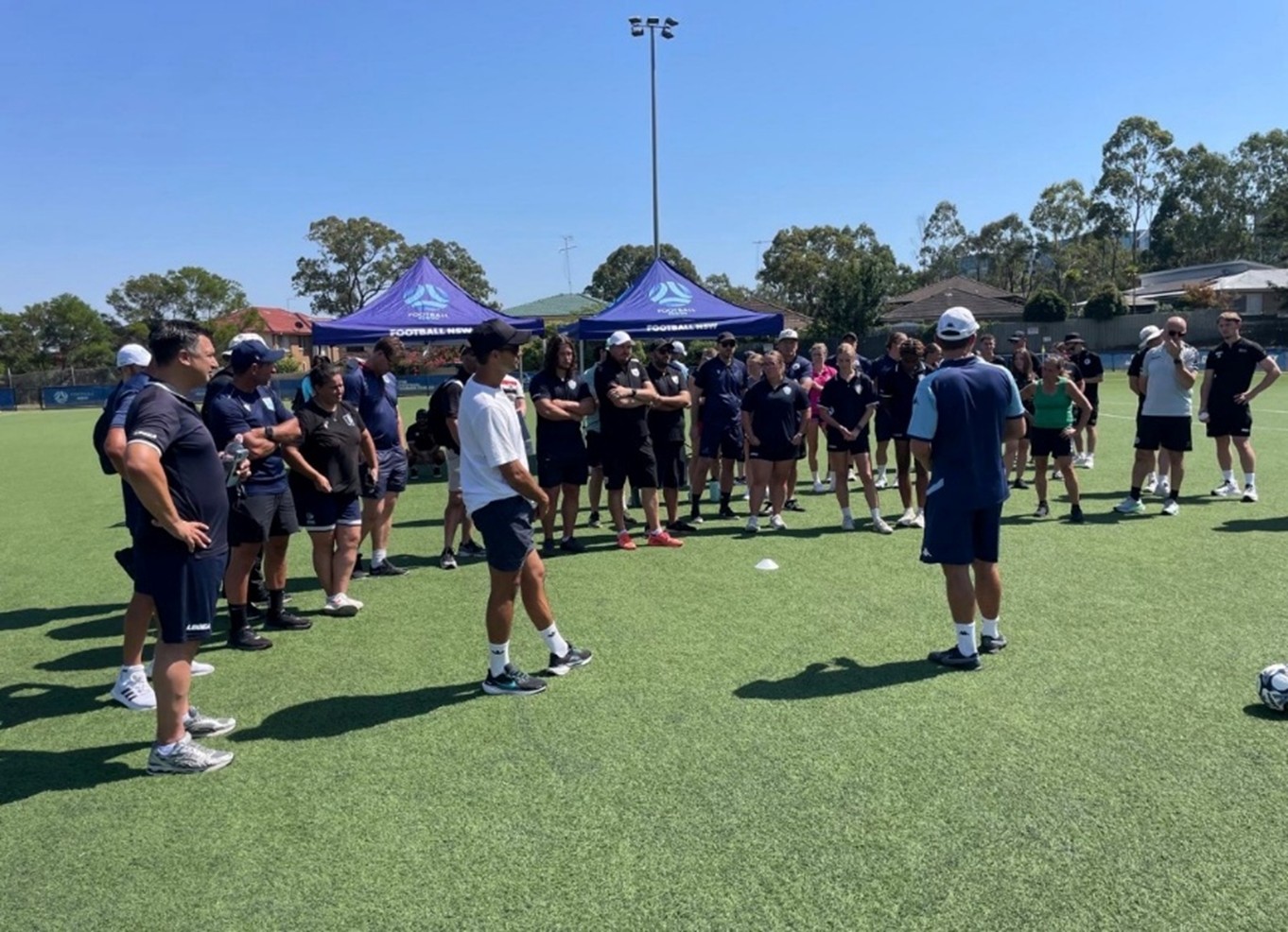 a group of people playing a game of frisbee
