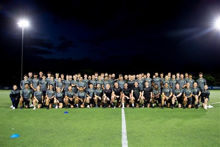 a group of people standing in front of a crowd