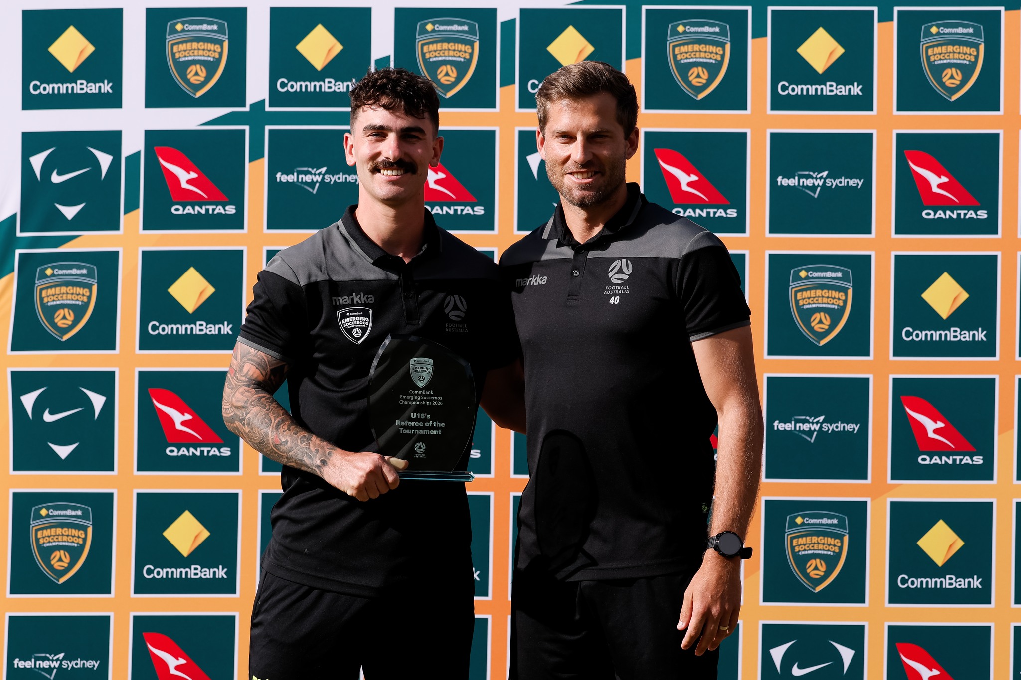 a man holding a sign posing for the camera