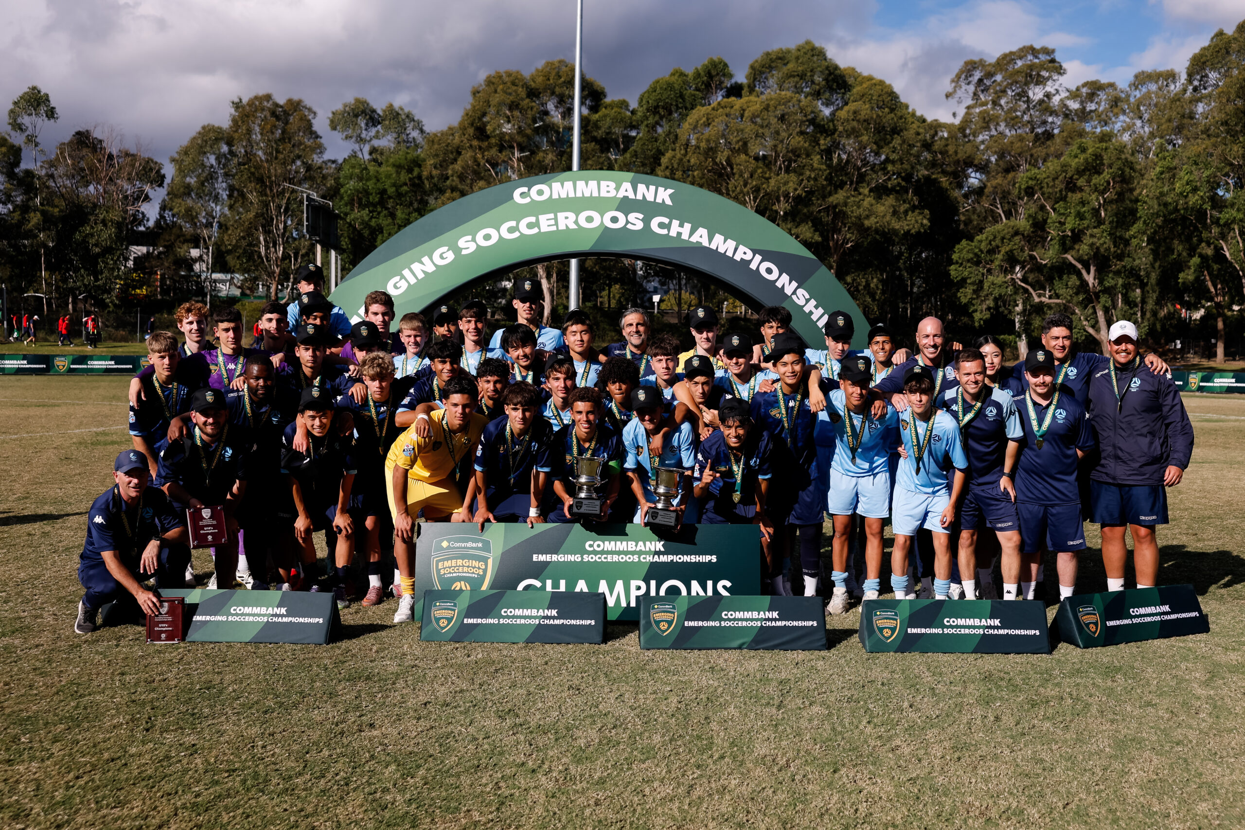 a group of people standing in front of a crowd posing for the camera
