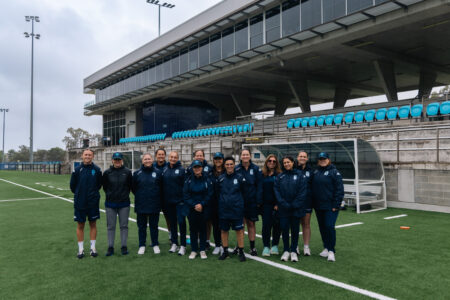 a group of people that are standing in the grass