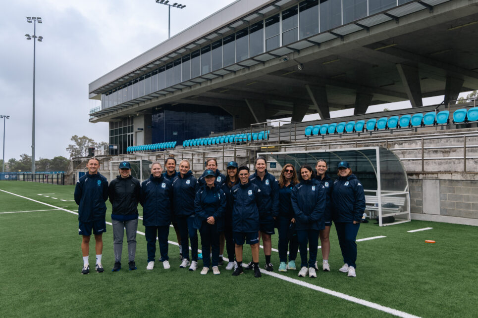 a group of people that are standing in the grass