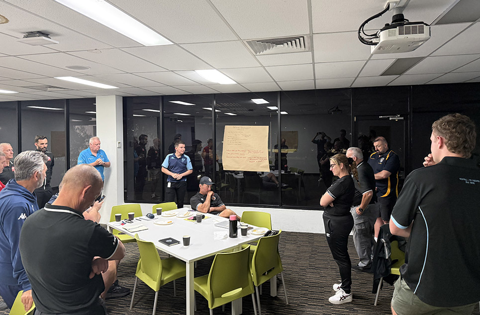 a group of people standing around a table