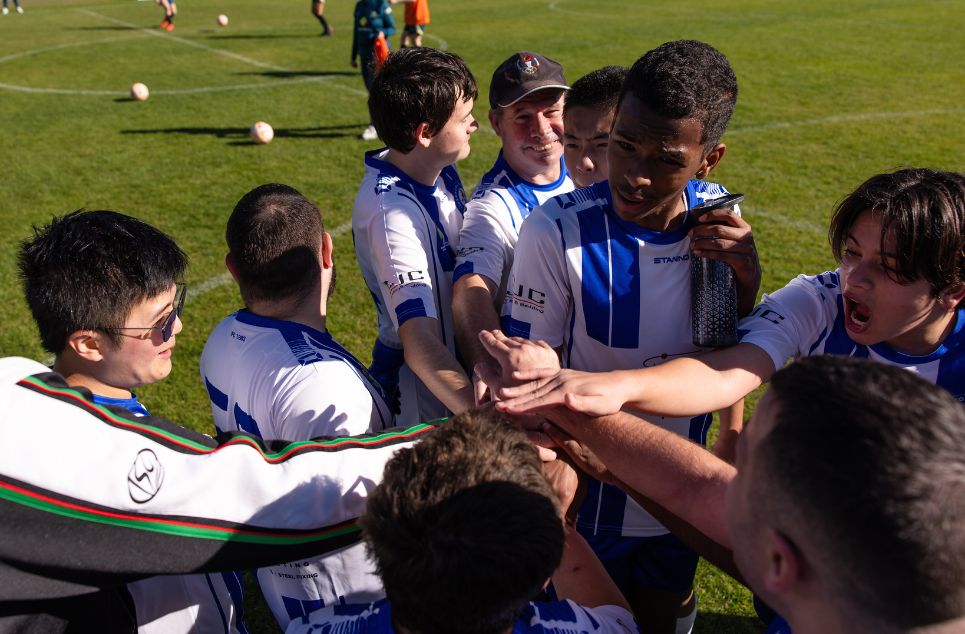 a group of people watching a football ball