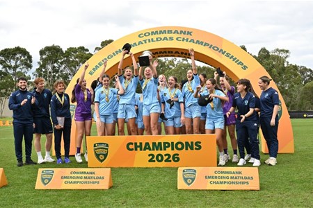 a group of people standing in front of a crowd posing for the camera