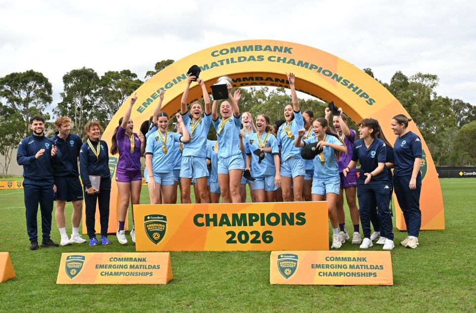 a group of people standing in front of a crowd posing for the camera