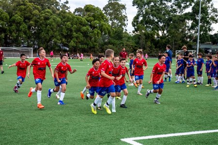 a group of people playing football on a field