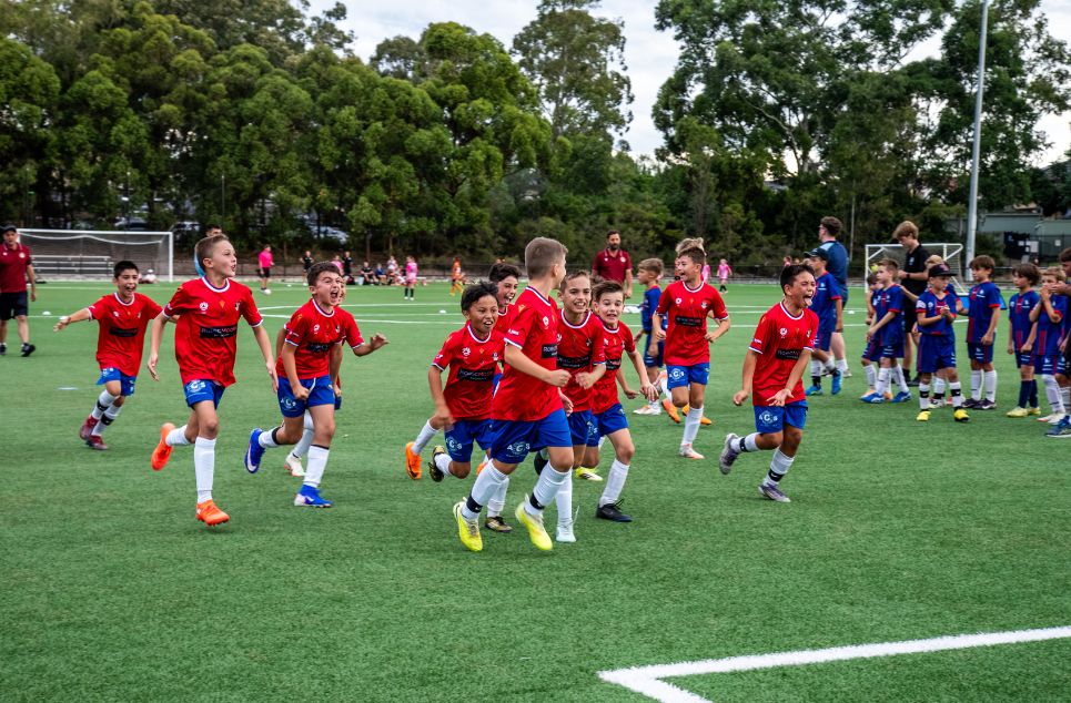 a group of people playing football on a field