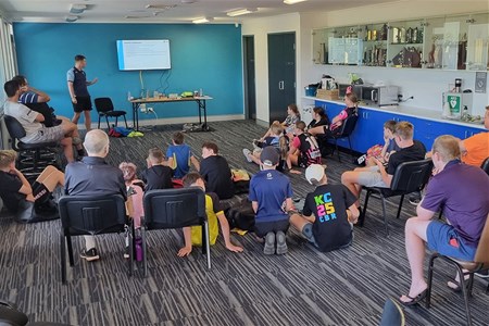 a group of people sitting at a table in a room