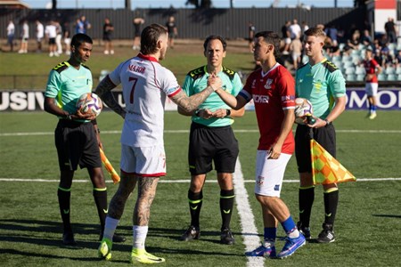a group of people playing football on a field
