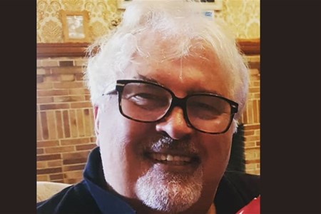 a man wearing glasses and looking at the camera