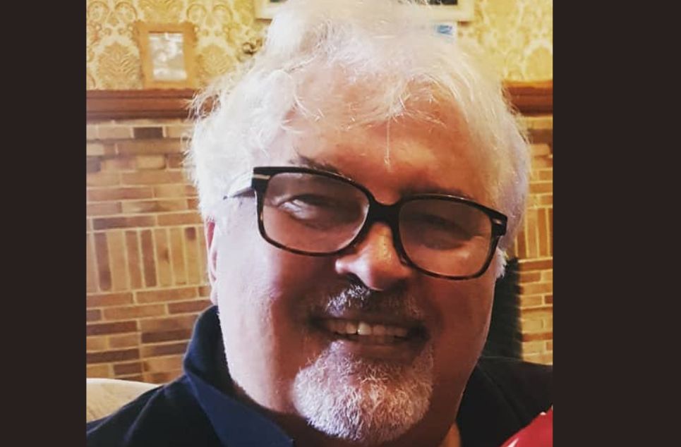 a man wearing glasses and looking at the camera