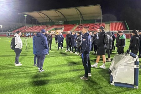 a group of people that are standing in the grass