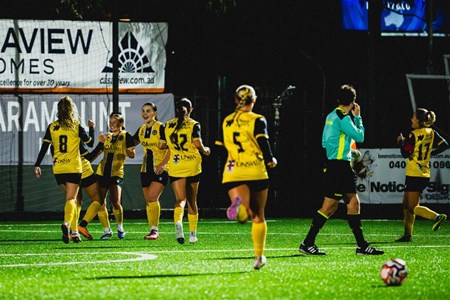 a group of people playing football on a field