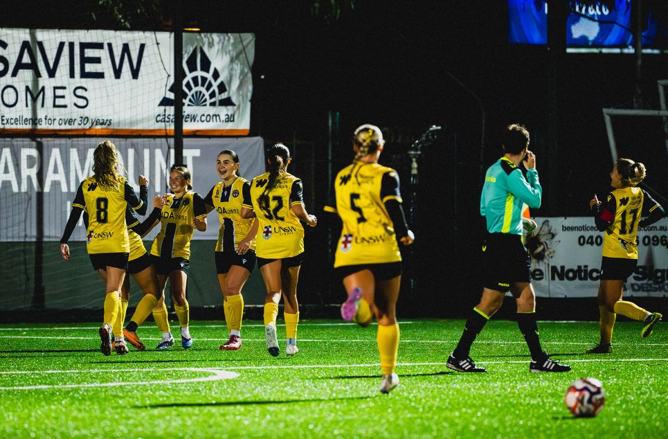 a group of people playing football on a field