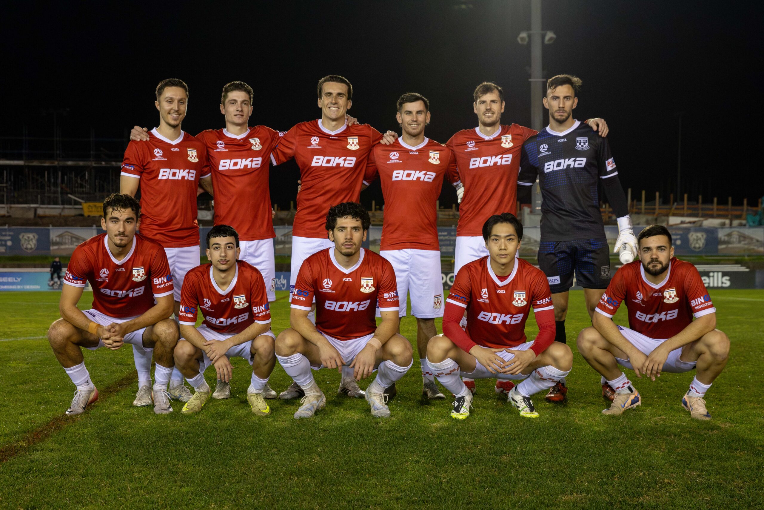 a group of football players posing for a photo
