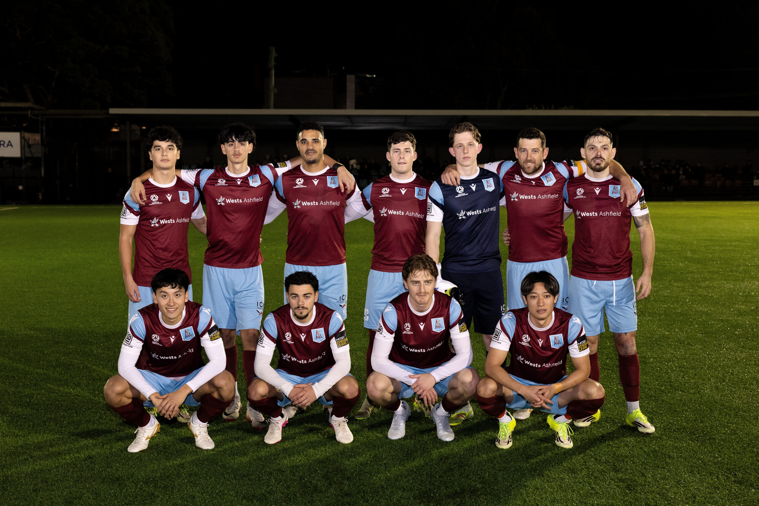 a group of football players posing for a photo