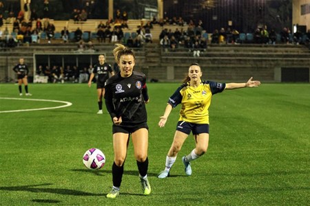 a group of people playing football on a field
