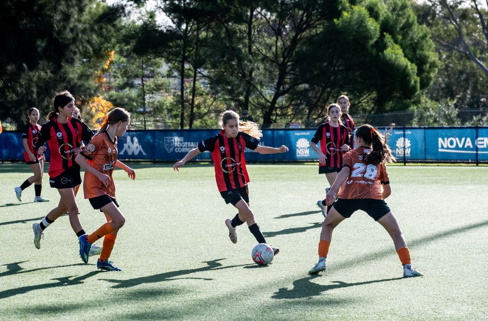 a group of young people playing a game of football