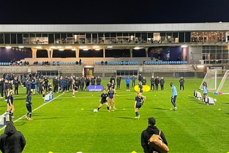 a group of people playing football on a field