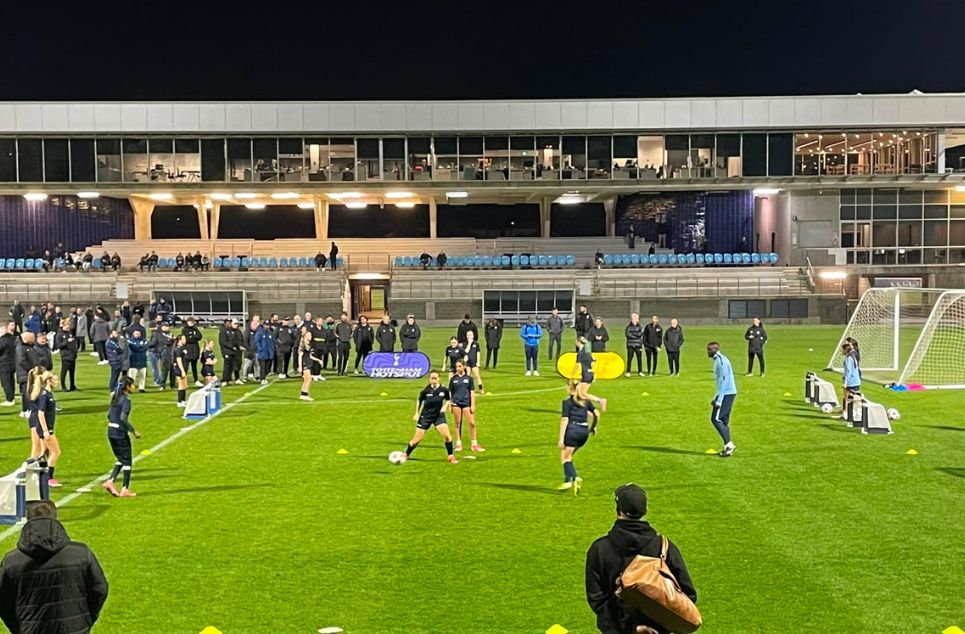 a group of people playing football on a field