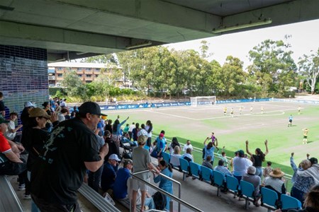 a group of people watching a fence and building