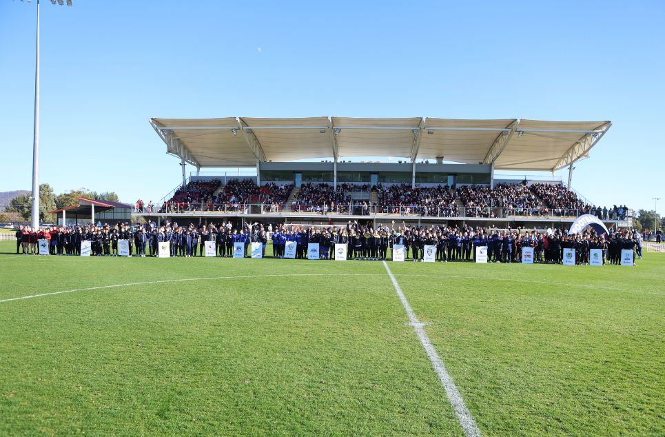 a stadium with people in the field