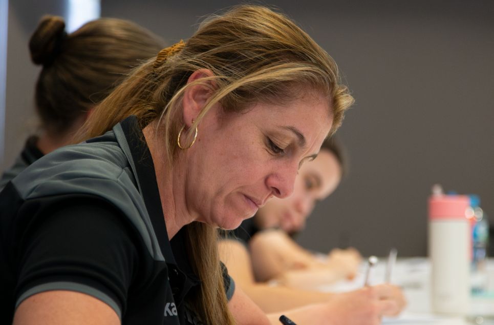 a woman sitting at a table eating food