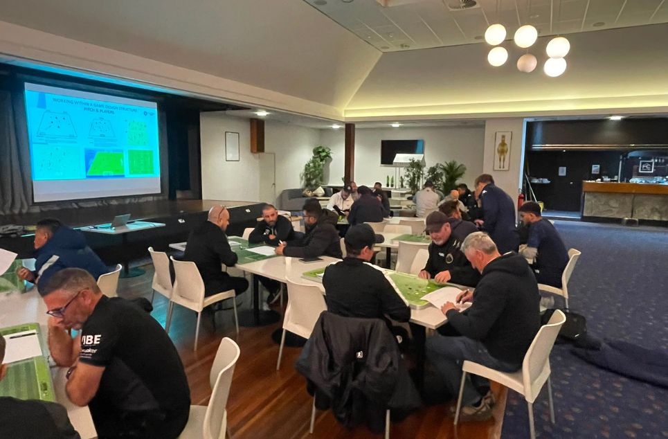 a group of people sitting at a table in a room