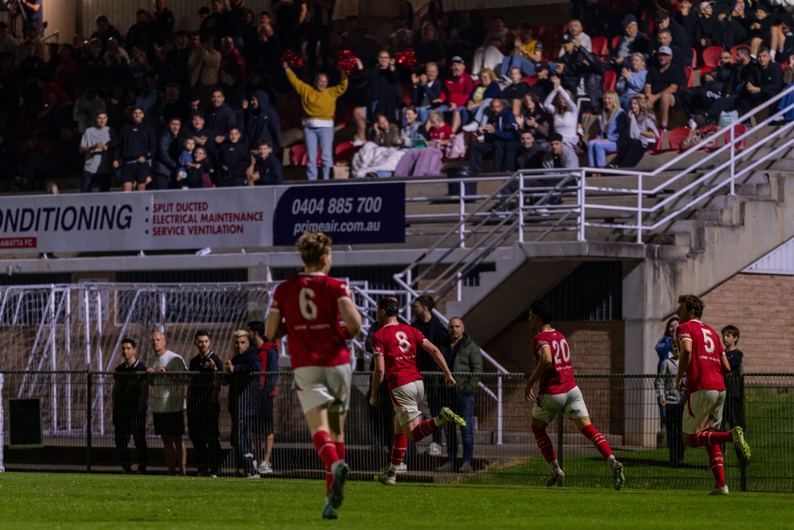 a crowd of people watching a football game
