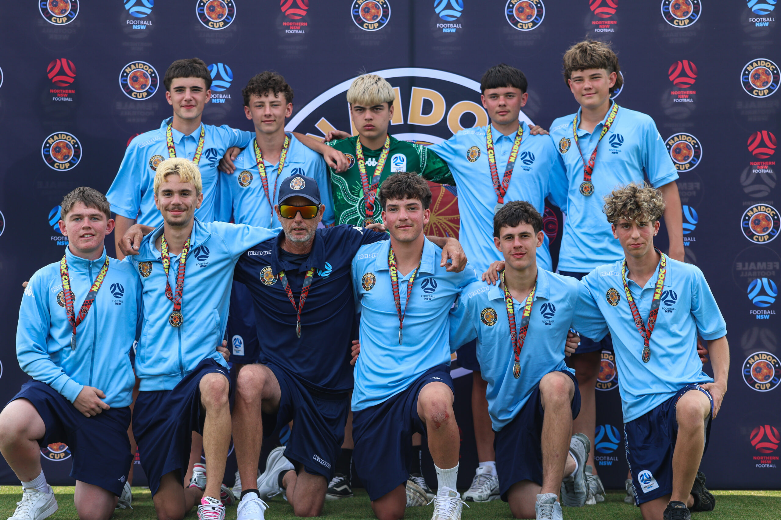 a group of football players posing for a photo