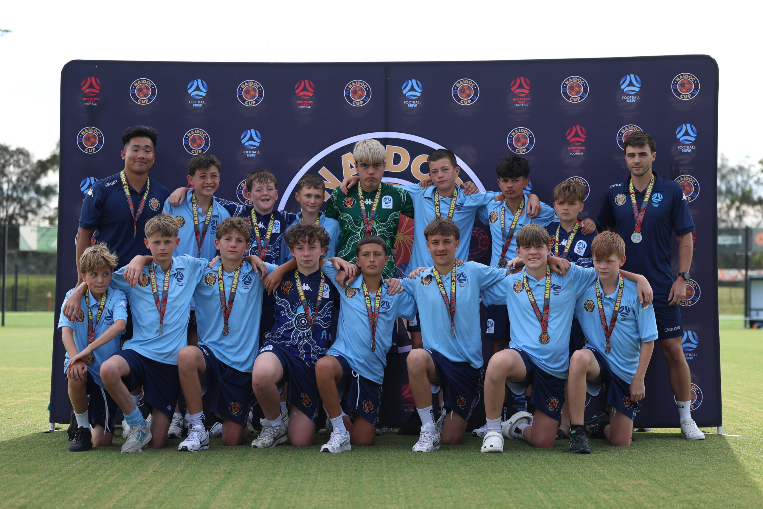 a group of football players posing for a photo