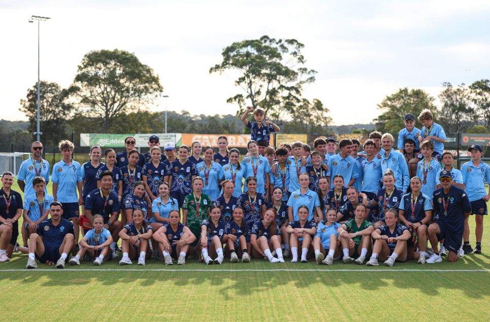 a group of people standing in front of a crowd posing for the camera